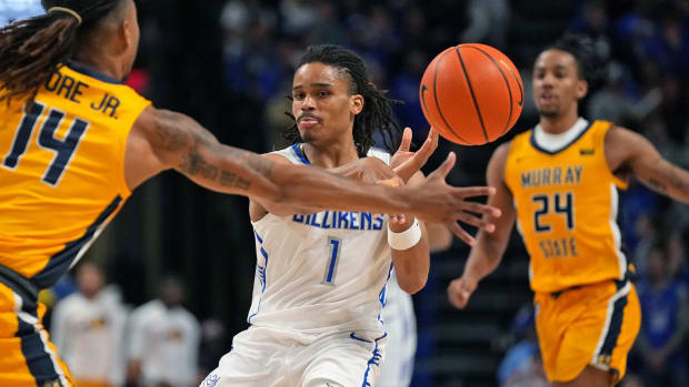Saint Louis guard Yuri Collins passes the ball